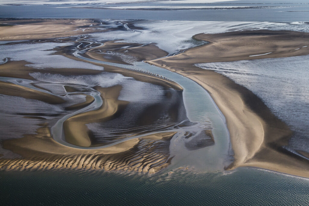 Luftaufnahme von mäandernen Wasserläufen bei Niedrigwasser